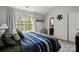 Bright bedroom features natural light from window and ensuite bathroom access at 10920 Walking Path Ln, Charlotte, NC 28213
