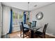 Bright dining area features wood floors, modern lighting, and a decorative mirror at 10920 Walking Path Ln, Charlotte, NC 28213