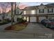 Well-maintained townhome exterior featuring attached garages and landscaped front yards at 10920 Walking Path Ln, Charlotte, NC 28213