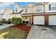 Inviting townhouse with well-kept front yard, garage, and appealing facade at 10920 Walking Path Ln, Charlotte, NC 28213