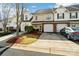 Attractive townhouse featuring a well-maintained lawn, garage, and inviting curb appeal at 10920 Walking Path Ln, Charlotte, NC 28213
