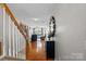 Bright foyer with hardwood floors and staircase leading to the upper level at 10920 Walking Path Ln, Charlotte, NC 28213