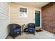 Welcoming front porch with seating area, creating a cozy and inviting entryway at 10920 Walking Path Ln, Charlotte, NC 28213