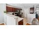 Modern kitchen featuring dark wood cabinets, stainless steel appliances, and a breakfast bar at 10920 Walking Path Ln, Charlotte, NC 28213