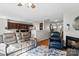 Open-concept living area with hardwood floors, a fireplace, and a view of the kitchen at 10920 Walking Path Ln, Charlotte, NC 28213