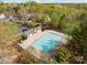 Aerial view of community pool surrounded by trees, with plenty of space for residents to enjoy at 10920 Walking Path Ln, Charlotte, NC 28213