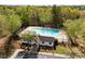 Community pool with a large swimming area and a pool house with parking at 10920 Walking Path Ln, Charlotte, NC 28213