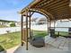 Backyard patio area featuring shaded pergola structure with hanging lights and seating at 110 Lantern Acres Dr, Mooresville, NC 28115