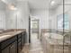 Bright bathroom with double vanity sinks and a separate tub and shower area at 110 Lantern Acres Dr, Mooresville, NC 28115