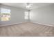 Spacious bedroom with carpet, two windows, and neutral walls providing a serene atmosphere at 110 Lantern Acres Dr, Mooresville, NC 28115