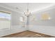 Dining room features chair rail molding, hardwood floors, and three large windows that provide natural light at 110 Lantern Acres Dr, Mooresville, NC 28115
