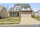 Charming two-story home featuring a stone facade, covered porch, and attached two-car garage at 110 Lantern Acres Dr, Mooresville, NC 28115