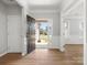 Bright foyer with wood flooring, white wainscoting, and an open view of the home's front exterior at 110 Lantern Acres Dr, Mooresville, NC 28115