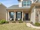 Inviting front porch with stone accents, seating, and well-maintained landscaping provides curb appeal at 110 Lantern Acres Dr, Mooresville, NC 28115
