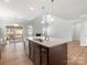 Open kitchen featuring a large granite island with stainless steel sink perfect for entertaining guests at 110 Lantern Acres Dr, Mooresville, NC 28115