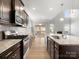 Open kitchen offers granite countertops, a gas stove, dark cabinets, and a center island at 110 Lantern Acres Dr, Mooresville, NC 28115
