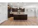 Modern kitchen features dark wood cabinetry, stainless steel appliances, and granite countertops at 110 Lantern Acres Dr, Mooresville, NC 28115