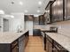 Open kitchen with dark cabinetry, stainless steel appliances, granite countertops, and center island at 110 Lantern Acres Dr, Mooresville, NC 28115