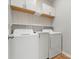Conveniently located laundry room with built in shelving, washer, and dryer for efficient chores at 110 Lantern Acres Dr, Mooresville, NC 28115