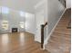 Living room with fireplace, staircase, and plenty of natural light from large windows create a cozy space at 110 Lantern Acres Dr, Mooresville, NC 28115