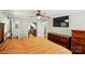 Cozy bedroom with hardwood floors, a ceiling fan, and a view into the ensuite bathroom at 110 Tanglewood Dr, Kannapolis, NC 28081