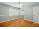 Bright bedroom featuring hardwood flooring, ceiling fan and mirror closet at 110 Tanglewood Dr, Kannapolis, NC 28081