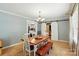 Inviting dining room with a rustic table, chandelier lighting, and sliding barn doors at 110 Tanglewood Dr, Kannapolis, NC 28081