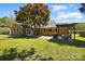 Picturesque brick home featuring a lush yard, pergola, and a mature shade tree at 110 Tanglewood Dr, Kannapolis, NC 28081