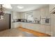 Well-lit kitchen with white cabinets, stainless steel appliances, and a charming window view at 110 Tanglewood Dr, Kannapolis, NC 28081