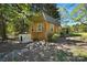 Cozy wooden outbuilding with windows and a metal roof, set in a tranquil, wooded area at 110 Tanglewood Dr, Kannapolis, NC 28081