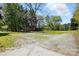Expansive view of the property featuring a building, wooden structure, and lush greenery at 110 Tanglewood Dr, Kannapolis, NC 28081