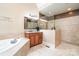 Elegant bathroom features a soaking tub, single vanity, and a glass enclosed shower at 112 Spring Branch Rd, Fort Mill, SC 29715