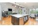 Open concept kitchen with a large center island, stainless steel appliances, and views of the living room at 112 Spring Branch Rd, Fort Mill, SC 29715
