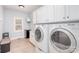 Well-equipped laundry room featuring a washer, dryer, cabinetry, and natural light for efficient chores at 112 Spring Branch Rd, Fort Mill, SC 29715