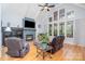 Spacious living room with a fireplace, large windows providing natural light, and comfortable seating, ideal for gatherings at 112 Spring Branch Rd, Fort Mill, SC 29715