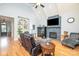 Bright living room featuring a stone fireplace, vaulted ceilings, and cozy seating area for relaxation and entertainment at 112 Spring Branch Rd, Fort Mill, SC 29715