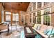 Relaxing screened porch features brick, high ceilings, plush seating, and an outdoor fireplace at 112 Spring Branch Rd, Fort Mill, SC 29715