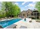 Luxury backyard showcasing a sparkling pool, sun loungers, and patio space ideal for outdoor entertaining at 112 Spring Branch Rd, Fort Mill, SC 29715