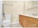 Well-lit bathroom featuring a wood vanity and tile floor at 115 Green Sw St, Concord, NC 28027