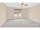 Neutral bedroom with carpeted floor, ceiling fan, and large window for natural light at 115 Green Sw St, Concord, NC 28027