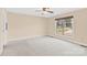 Bedroom with carpet floors, a ceiling fan, and a large window at 115 Green Sw St, Concord, NC 28027