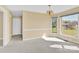 Well-lit dining area with a window view, neutral walls, and adjacent doorway creates an inviting atmosphere at 115 Green Sw St, Concord, NC 28027