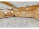 Open garage with wood paneling, work bench and storage shelves at 115 Green Sw St, Concord, NC 28027