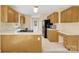 Kitchen features wooden cabinets, tile floors, and white countertops at 115 Green Sw St, Concord, NC 28027
