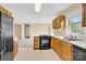 Open kitchen layout with a black refrigerator and wooden cabinets at 115 Green Sw St, Concord, NC 28027