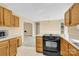 Spacious kitchen with wooden cabinets and a built-in cooktop at 115 Green Sw St, Concord, NC 28027