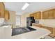 Kitchen features wooden cabinets, an island with an electric cooktop, and tile flooring at 115 Green Sw St, Concord, NC 28027