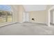 Spacious living room features a large window, neutral paint, and plush carpeting for comfort at 115 Green Sw St, Concord, NC 28027