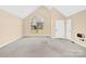 Bright, airy living room with a large window and neutral carpeting creates a welcoming space at 115 Green Sw St, Concord, NC 28027