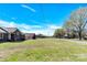 Brick home with a lush front lawn and tree-lined street at 115 Green Sw St, Concord, NC 28027